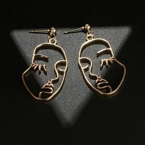 Gold face drop earrings